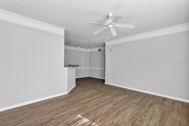 interior space with crown molding, baseboards, ceiling fan, rail lighting, and wood finished floors