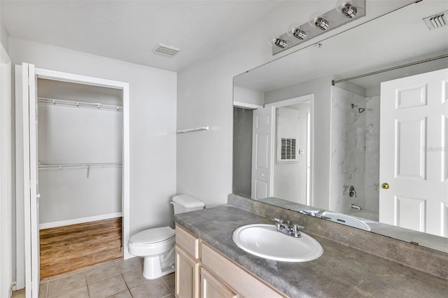 bathroom featuring vanity, tile patterned floors, toilet, and visible vents