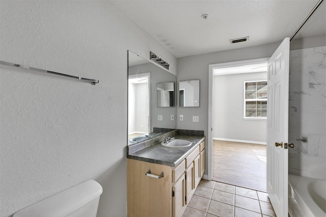 full bathroom with tile patterned floors, visible vents, toilet, and vanity