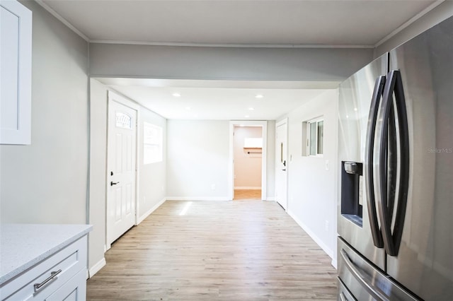 kitchen featuring light stone counters, recessed lighting, stainless steel fridge, light wood-style floors, and baseboards