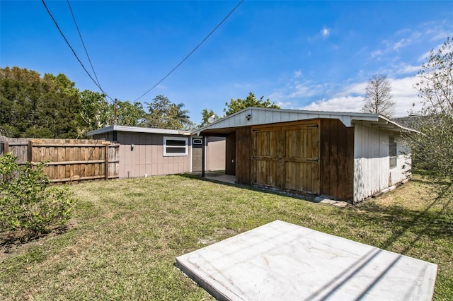 exterior space with an outdoor structure, a patio, and fence