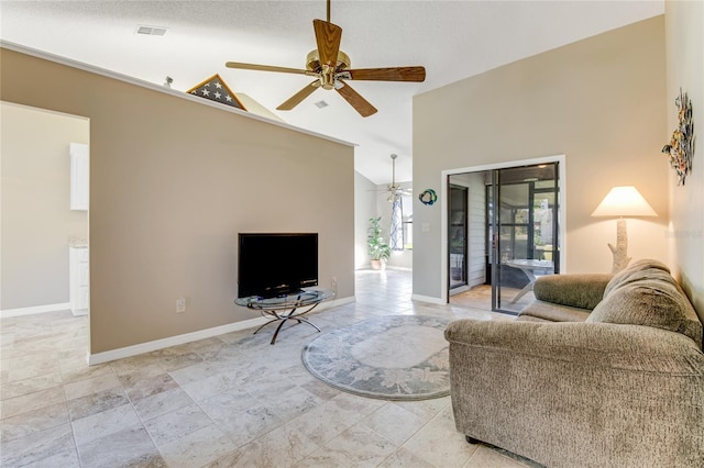 living area featuring visible vents, baseboards, a ceiling fan, and high vaulted ceiling