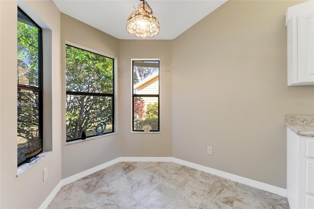 dining area featuring an inviting chandelier and baseboards