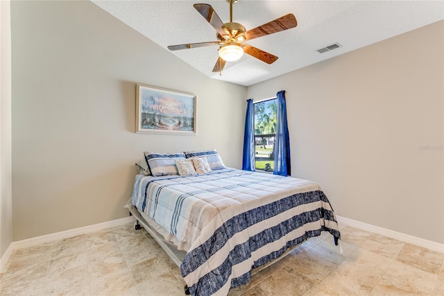 bedroom with visible vents, baseboards, a textured ceiling, and lofted ceiling