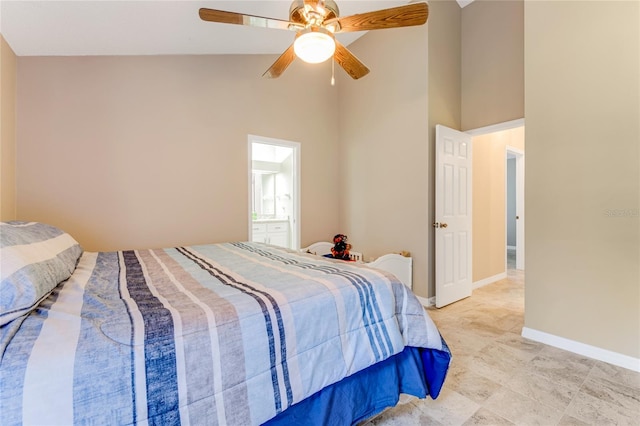 bedroom with ceiling fan, connected bathroom, baseboards, and high vaulted ceiling