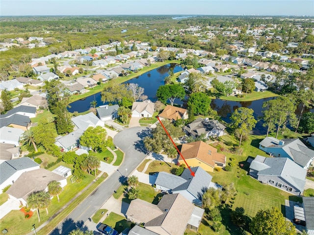 drone / aerial view featuring a residential view and a water view