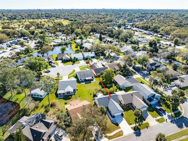 drone / aerial view with a residential view and a water view