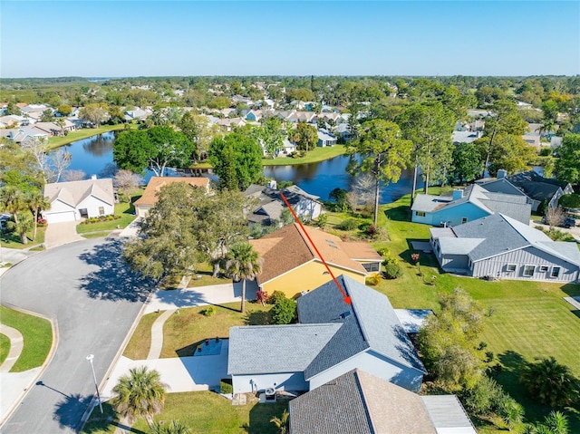 birds eye view of property with a residential view and a water view