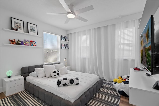 bedroom with ceiling fan and wood finished floors