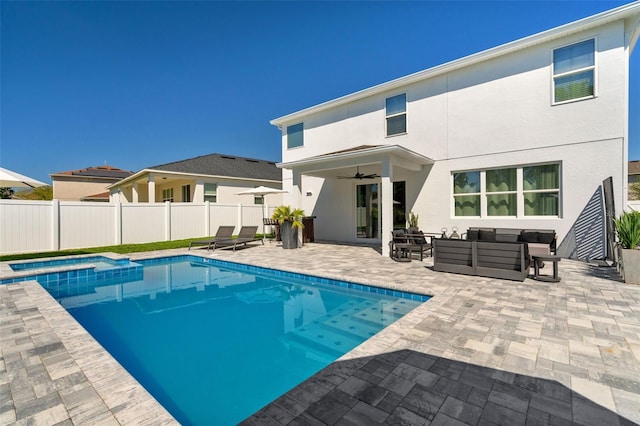 view of swimming pool featuring fence, an outdoor living space, a pool with connected hot tub, ceiling fan, and a patio area