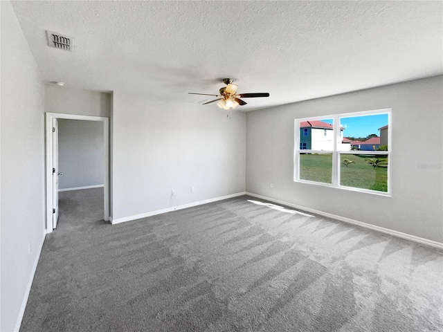 carpeted empty room with visible vents, baseboards, a textured ceiling, and a ceiling fan