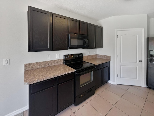 kitchen with baseboards, a textured ceiling, black appliances, and light tile patterned flooring