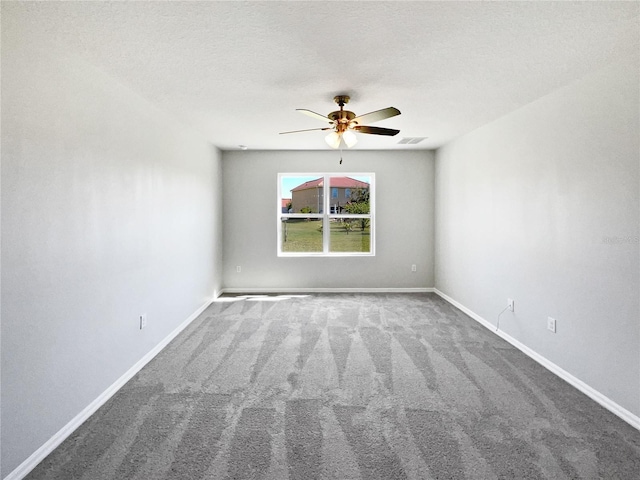 carpeted empty room with visible vents, baseboards, a textured ceiling, and ceiling fan