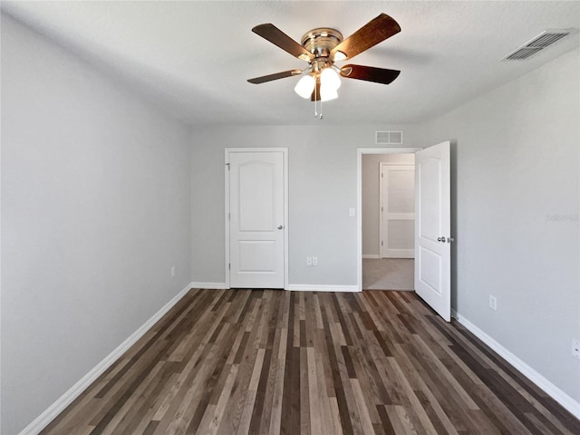 unfurnished bedroom with visible vents, ceiling fan, baseboards, and wood finished floors