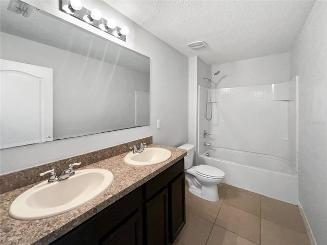 full bathroom featuring tile patterned flooring, a textured ceiling, toilet, and a sink