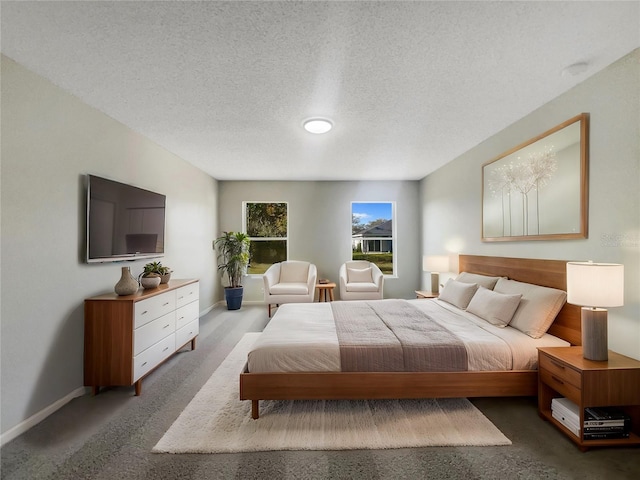 bedroom with baseboards and a textured ceiling