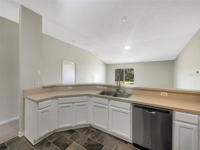 kitchen featuring stainless steel dishwasher, light countertops, white cabinetry, and a sink