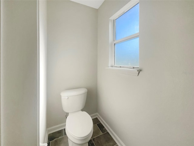 bathroom featuring tile patterned floors, toilet, and baseboards