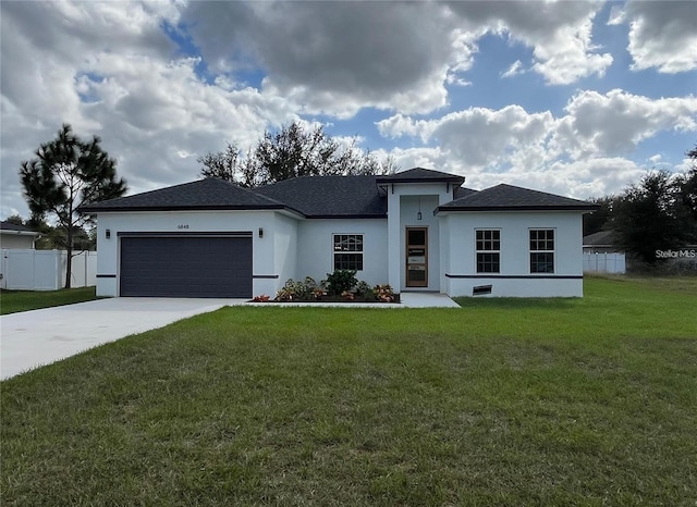 view of front facade with stucco siding, a front lawn, a garage, and fence