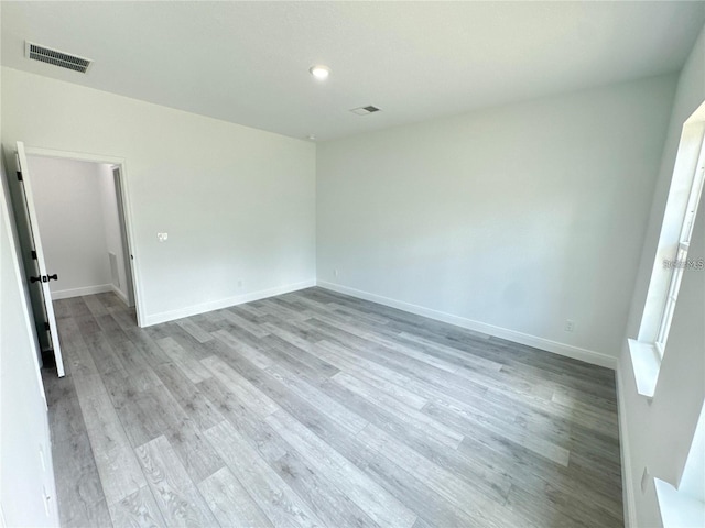 unfurnished bedroom featuring light wood-type flooring, visible vents, and baseboards