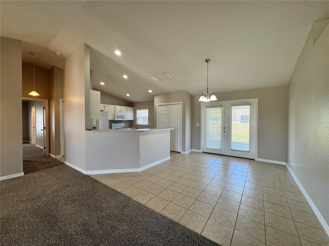 interior space with light tile patterned floors, baseboards, recessed lighting, vaulted ceiling, and a chandelier