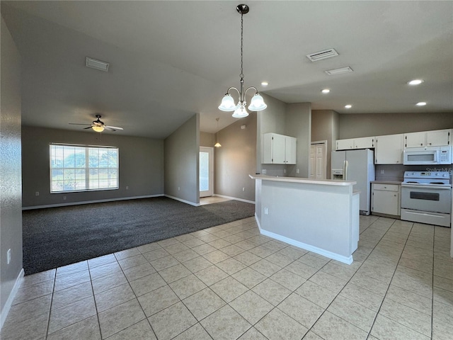 kitchen with light tile patterned floors, white appliances, vaulted ceiling, and white cabinetry