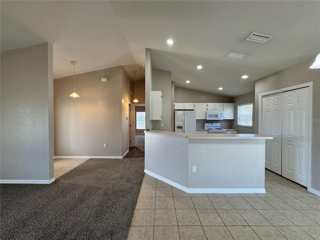 kitchen with white cabinetry, white appliances, light tile patterned floors, light colored carpet, and vaulted ceiling