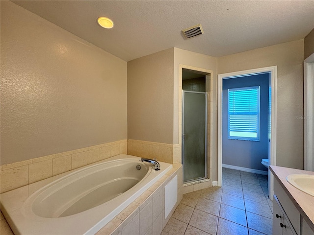 bathroom featuring vanity, visible vents, tile patterned flooring, a shower stall, and toilet