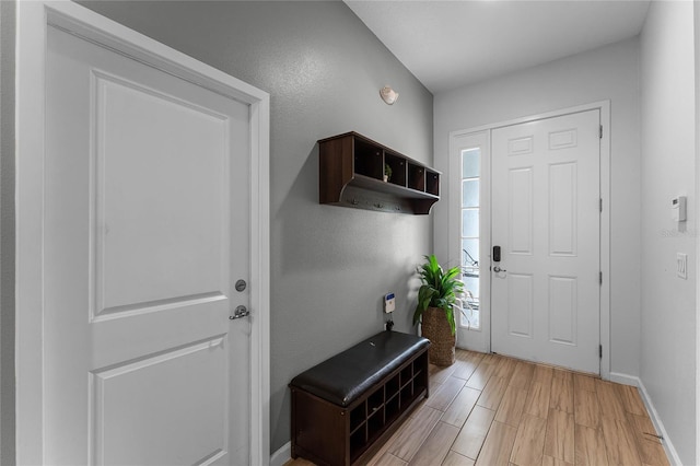 foyer featuring light wood-type flooring and baseboards