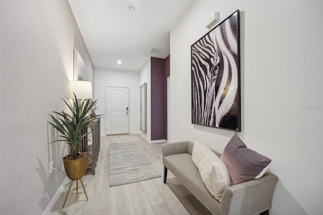 corridor featuring recessed lighting, baseboards, and light wood-style flooring