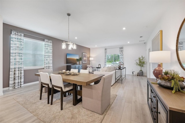 dining space featuring recessed lighting, a notable chandelier, and light wood-style flooring