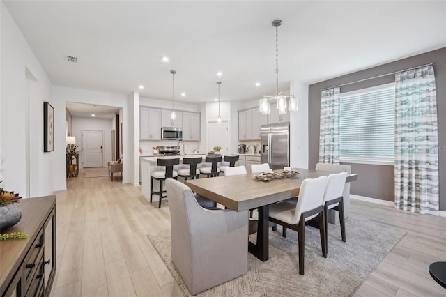 dining area with recessed lighting, visible vents, baseboards, and light wood-style floors