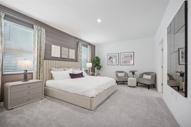 bedroom featuring carpet floors and wood walls