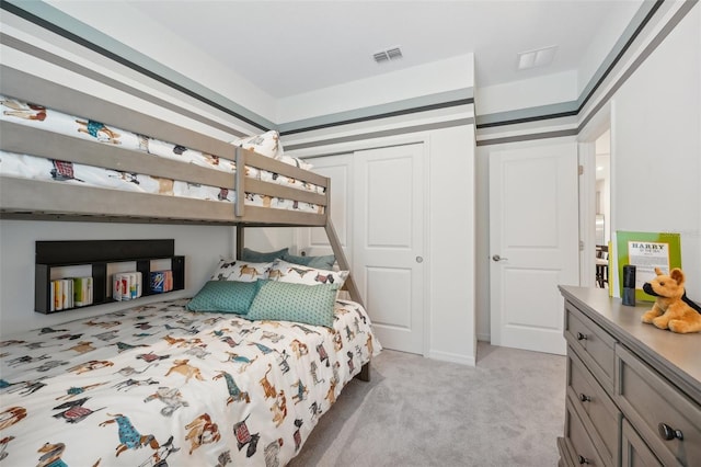 bedroom featuring visible vents and light carpet