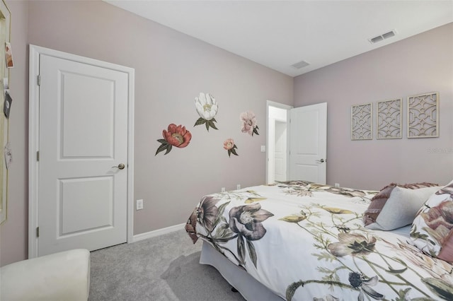 bedroom with visible vents, baseboards, and carpet