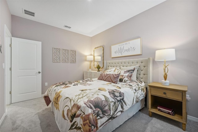 bedroom with baseboards, visible vents, and carpet floors