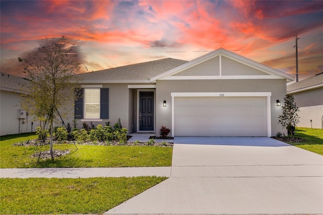 ranch-style home featuring stucco siding, concrete driveway, a lawn, and a garage