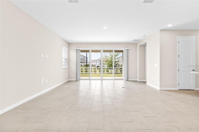 unfurnished room featuring recessed lighting, visible vents, and baseboards