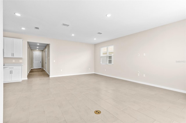 unfurnished living room featuring recessed lighting, baseboards, and visible vents