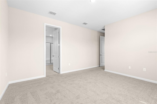 unfurnished bedroom featuring visible vents, carpet floors, and baseboards