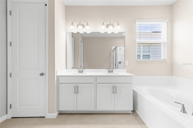 full bathroom featuring a shower stall, a bath, double vanity, and a sink