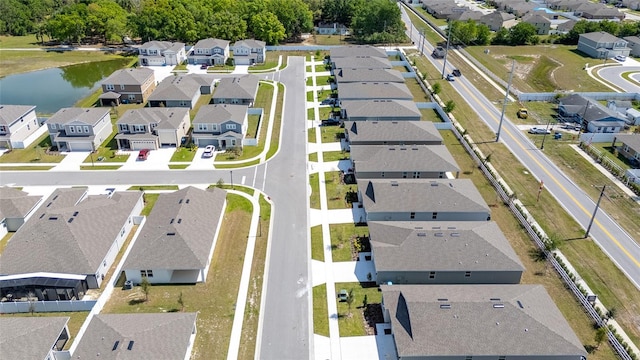 drone / aerial view featuring a residential view and a water view