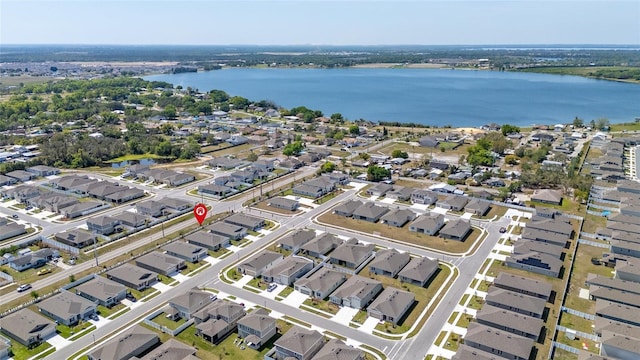 drone / aerial view featuring a residential view and a water view