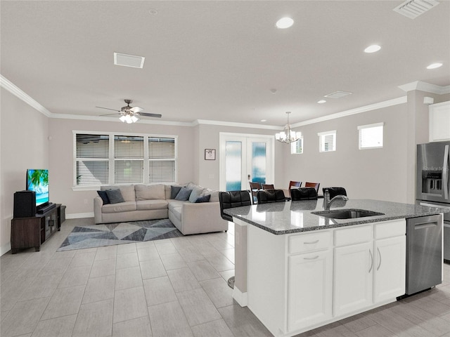 kitchen with visible vents, a sink, dishwasher, stone countertops, and a kitchen island with sink