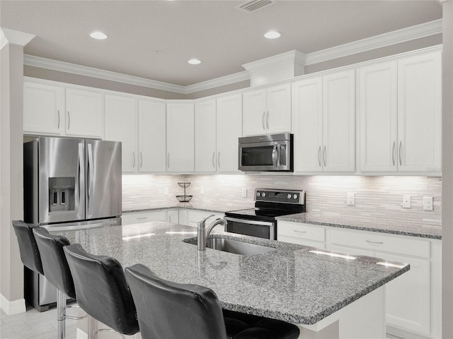 kitchen featuring a sink, crown molding, tasteful backsplash, and stainless steel appliances