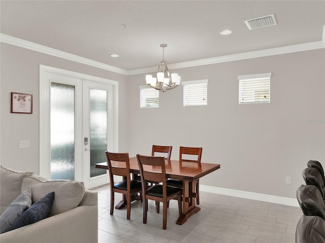 dining space with visible vents, french doors, an inviting chandelier, and ornamental molding