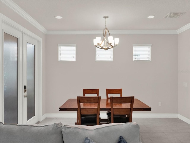 dining area featuring ornamental molding, a healthy amount of sunlight, visible vents, and a chandelier