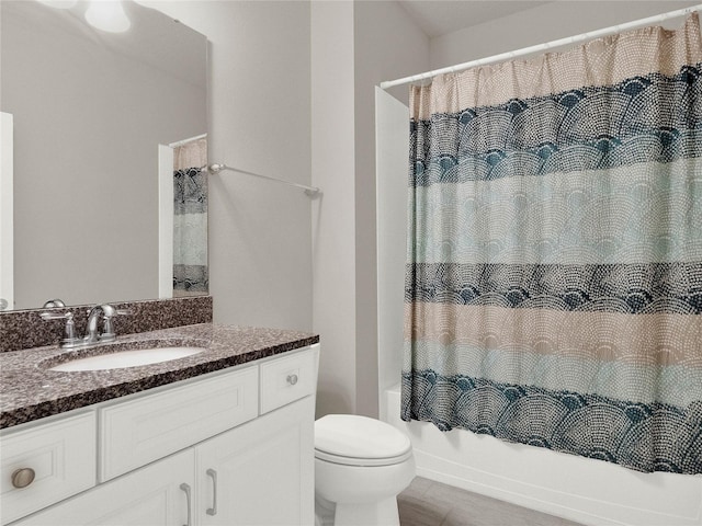 full bath featuring shower / bath combo with shower curtain, toilet, and vanity