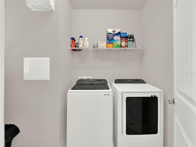 clothes washing area featuring washing machine and dryer and laundry area