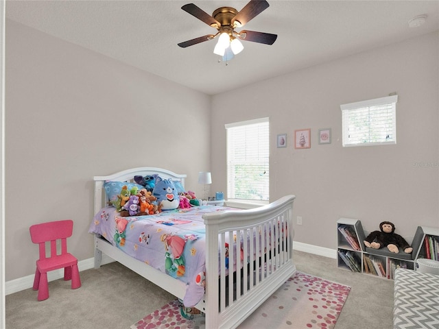 bedroom with ceiling fan, baseboards, and carpet